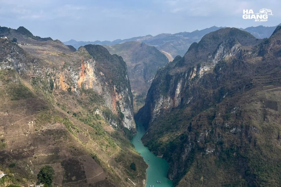 Looking up from a boat in Tu San Canyon to Ma Pi Leng Pass road above